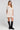 Front view of a woman wearing the Saltwater Luxe Nicko Natural Mini Dress on a neutral background