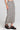 Side angle view of a woman wearing the Saltwater Luxe Nolla Midi Skirt on a neutral background
