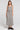 A full body front view of a woman wearing the Saltwater Luxe Nolla Midi Skirt on a neutral background