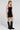 Side angle view of a woman wearing the Saltwater Luxe Oaklyn Midi Dress on a neutral background