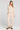 Full body front view of a woman wearing the Saltwater Luxe Perry Pullover in Oat on a neutral background