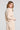 Back view of a woman wearing the Saltwater Luxe Perry Pullover in Oat on a neutral background