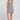 Front view of a woman wearing the Saltwater Luxe Pettra Mini Dress on a neutral background