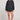 Full body front view of a woman wearing the Saltwater Luxe Pull On Black Shorts on a neutral background