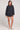 Full body front view of a woman wearing the Saltwater Luxe Pull On Black Shorts on a neutral background