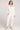 A full body front view of a woman wearing the Saltwater Luxe Pull On Ecru Jogger Pant on a neutral background