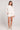 Full body front view of a woman wearing the Saltwater Luxe Pull On Ecru Shorts on a neutral background