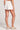 Back view of a woman wearing the Saltwater Luxe Pull On Ecru Shorts on a neutral background