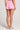 Back view of a woman wearing the Saltwater Luxe Pull On Petunia Shorts on a neutral background