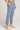 Side angle view of a woman wearing the Saltwater Luxe Pull On Worn Blue Jogger Pant on a neutral background