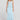 Full body front view of a woman wearing the Saltwater Luxe  Rainer Midi Skirt in Azure Blue on a neutral background
