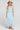 Full body front view of a woman wearing the Saltwater Luxe  Rainer Midi Skirt in Azure Blue on a neutral background