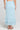 Back view of a woman wearing the Saltwater Luxe  Rainer Midi Skirt in Azure Blue on a neutral background