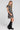 Side angle view of a woman wearing the Saltwater Luxe Raleigh Mini Dress on a neutral background