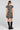 Back view of a woman wearing the Saltwater Luxe Raleigh Mini Dress on a neutral background