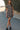 Front view of a woman wearing the Saltwater Luxe Raleigh Mini Dress on a road