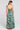 Back view of a woman wearing the Saltwater Luxe Rene Midi Dress on a neutral background