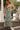 Front view of a woman wearing the Saltwater Luxe Rene Midi Dress in a garden