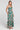 Side angle view of a woman wearing the Saltwater Luxe Rene Midi Dress on a neutral background