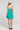 Back view of a woman wearing the Saltwater Luxe Renoa Mini Dress on a neutral background