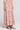 Side angle view of a woman wearing the Saltwater Luxe Rommie Multicolored Midi Skirt on a neutral background