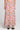 Back view of a woman wearing the Saltwater Luxe Rommie Multicolored Midi Skirt on a neutral background