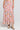 Front view of a woman wearing the Saltwater Luxe Rommie Multicolored Midi Skirt on a neutral background