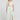 Full body front view of a woman wearing the Saltwater Luxe Rommie Pearl Midi Skirt on a neutral background