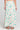 Back view of a woman wearing the Saltwater Luxe Rommie Pearl Midi Skirt on a neutral background