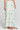 Side angle view of a woman wearing the Saltwater Luxe Rommie Pearl Midi Skirt on a neutral background