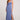 Full body view of woman wearing the Saltwater Luxe blue Cannan Midi Dress with a slit on a plain background