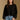 Model wearing the Saltwater Luxe Charmer Black Sweater with scattered metallic embellishments, front view