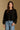 Model wearing the Saltwater Luxe Charmer Black Sweater with scattered metallic embellishments, front view