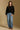 Model wearing the Saltwater Luxe Charmer Black Sweater with scattered metallic embellishments, full-body view