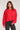 Front view of woman wearing the Saltwater Luxe Charmer Sweater in red with white heart patterns on a plain background