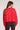Back view of woman wearing the Saltwater Luxe Charmer Sweater in red with white heart patterns on a plain backdrop
