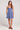Full body front view of a woman wearing the blue Saltwater Luxe Jazmyn Mini Dress against a plain background