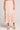 Cropped front view of a woman wearing the Saltwater Luxe floral Dagny Midi Skirt hat on a plain background