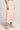 Cropped side view of a woman wearing the Saltwater Luxe floral Dagny Midi Skirt hat on a plain background