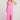 Front full body view of a woman wearing the Saltwater Luxe pink Hayley Midi Dress with a slit on a plain background