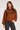 Front view of woman wearing the Saltwater Luxe brown Orson Sweater with patterned shoulders against a white background