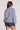 Back view of the Saltwater Luxe Ronnie Sweater in Dusty Blue highlighting the allover pink floral print and relaxed fit on a white background