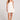 Front view of a woman wearing the Saltwater Luxe Augustina Salt White Mini Dress on a plain background