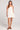 Front view of a woman wearing the Saltwater Luxe Augustina Salt White Mini Dress on a plain background