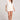 Front cropped view of a woman wearing the Saltwater Luxe Arabella salt white shorts with matching Leyah top on a plain background
