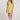 Front view of a woman wearing the Saltwater Luxe green Eldoris Willow Mini Dress with beige boots and a white hat on a plain background