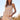 Outdoor shot of woman wearing the Saltwater Luxe Amaline beige striped top with matching Lionette Pant standing in a field with a clear blue sky