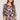 Saltwater Luxe Nykita Top in Black Floral front view featuring soft pink rose print, ruffle neckline detail, and three-quarter sleeves on a studio background
