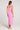 Back view of a woman wearing wearing the Saltwater Luxe Elowena Dahlia Pink Midi Dress against a plain background