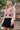 Front view of a woman wearing the Saltwater Luxe Andie Mini Skirt with Sladie Sweater